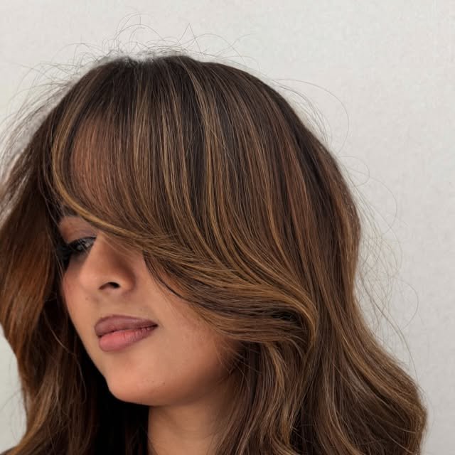 Cinnamon caramel brunette with a curtain fringe