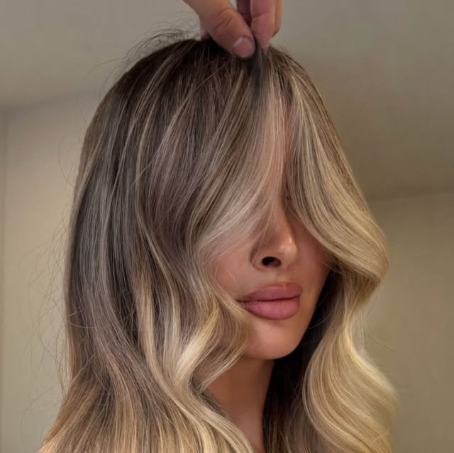 Lived-in blonde balayage with face-framing pieces
